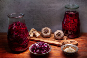 Beetroot salad with grated horseradish addition and fermented beetroot liquid. Bowls and glass jars.