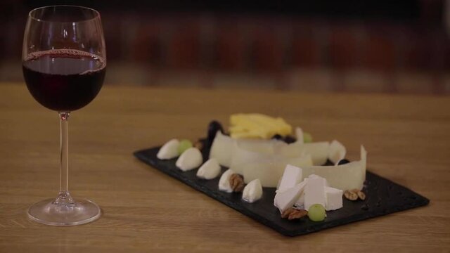 glass of natural red wine and appetizer   of chese
