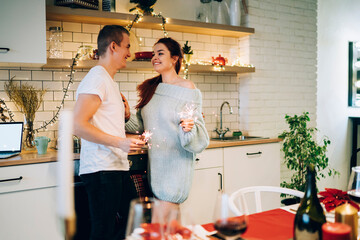 Smiling couple celebrating Christmas at apartment