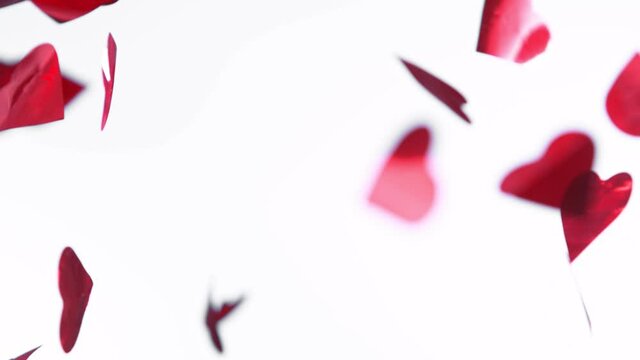 Red Hearts Fall on White Background. Super Slow Motion Filmed on High Speed Cinema Camera.