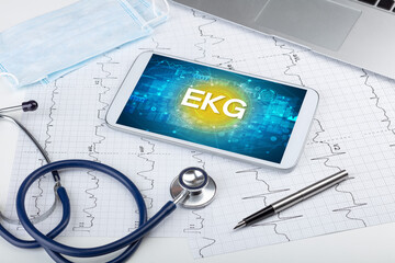 Close-up view of a tablet pc with EKG abbreviation, medical concept
