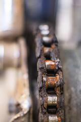 Mechanical device with gears and a chain inside. Part of the motorcycle engine close-up. Shine oil.