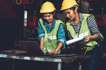 Factory job workers working and discussing manufacturing plan in the factory . Industry and...