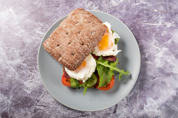 A square bun with eggs. A sandwich in a square bun. View from above.