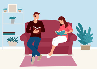 Couple reading book together on the sofa at home