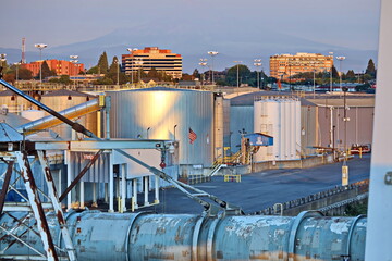 Cargo terminal for loading bulk cargo of cooper concentrates by shore cranes. View of piers and vessels under loading operation. Vancouver, WA, USA. August,2020.