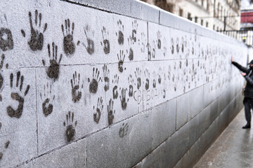 People put their hands to a frosted wall in support of Alexei Navalny during a rally against his...