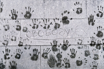Palm prints of people on a cold snowy frosted wall in support of illegally arrested Alexei Navalny...