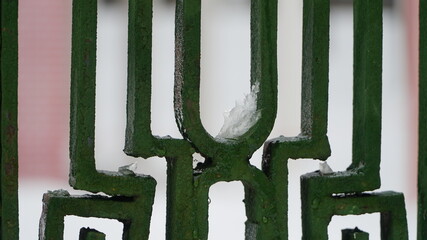 forged metal fence in winter