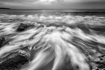Stunning black and white long exposure seascape at cloudy day.