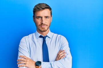 Handsome caucasian man wearing business shirt and tie skeptic and nervous, disapproving expression...