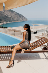  beautiful sexy woman with dark hair in elegant swimming suit and accessories