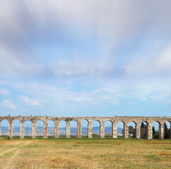 Flying clouds over aqueduct