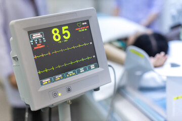 Electrocardiogram in hospital CT Scan room. heart rate monitor in hospital. Process of CT scanning of an old patient. Man Receiving a Medical Scan for a Trauma