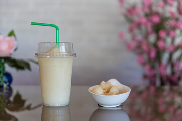 Cold smoothie lychee juice in plastic glass take away glass. Lychee fruity frappe. Lychee smoothie. 