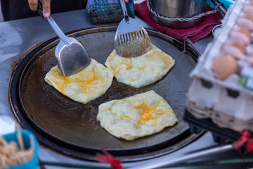 Roti Making, roti thresh flour by roti maker with oil. Indian traditional street food. Thai Pancake Banana And Egg . Thai Street Food and Desserts. Making of roti snack
