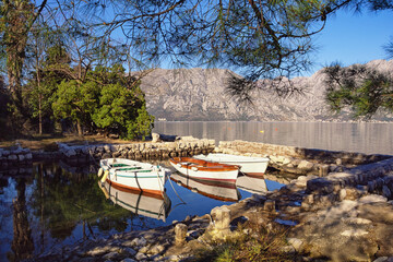 Sunny winter Mediterranean landscape. Montenegro, Adriatic Sea. View of  Kotor Bay. Small harbor for fishing boats near Prcanj town