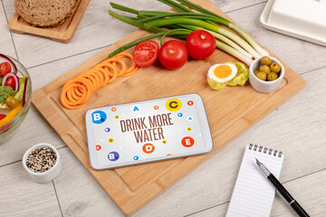 Healthy Tablet Pc compostion with DRINK MORE WATER inscription, weight loss concept