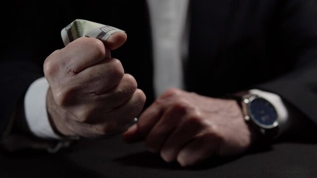 Angry annoyed businessman clenching in fist last hundred dollar bill, lost money