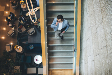 Businessman talking on smartphone on stairs