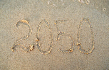 Fototapeta na wymiar New year, number 2050 on beach sand. Holiday concept. 2050 plan