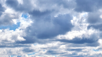 Dark clouds against a blue sky
