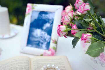 roses and photo frame in shabby chic style
