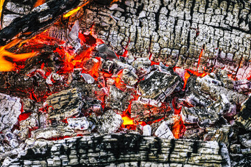 Brightly glowing red-hot charcoal. Firewood burnt to ashes.
