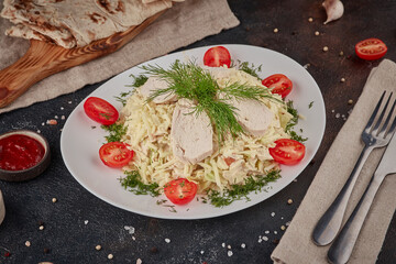 Caesar salad with chicken, textured dark background