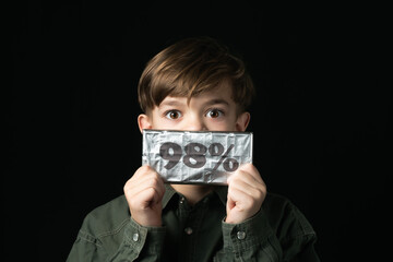  little boy holds a chocolate bar in foil