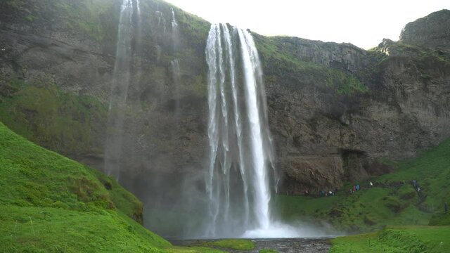 Gljufrabui, Iceland - May 2019: Gljufrabui waterfall with tourists walking, Iceland