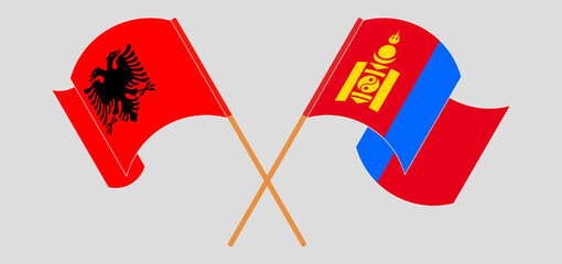 Crossed and waving flags of Albania and Mongolia