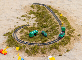 Toy Model railway on the Ground surrounded by grass