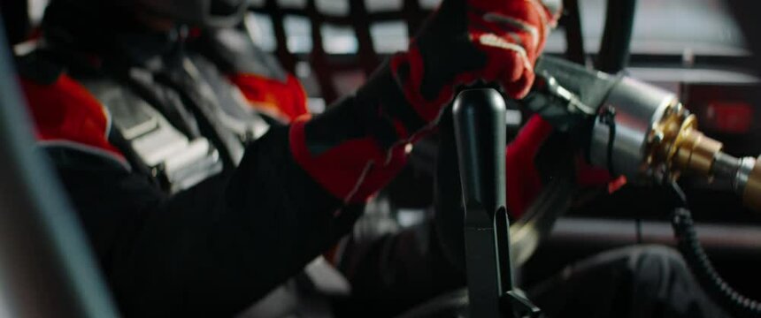 CU on gear shifter, driver of sports car driver starting a race on a speedway. Shot with 2x anamorphic lens