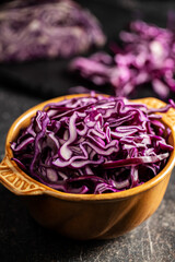 Sliced fresh red cabbage in bowl.