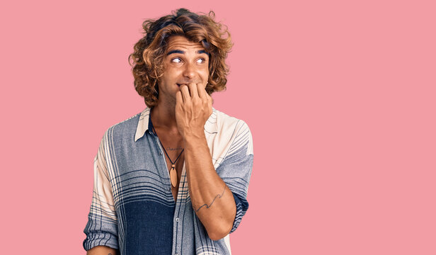 Young hispanic man wearing summer style looking stressed and nervous with hands on mouth biting nails. anxiety problem.