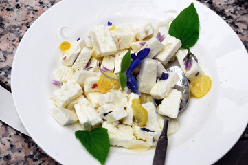Cheese salad with gentian sage and chives flowers and lemon - Schafskaesesalat