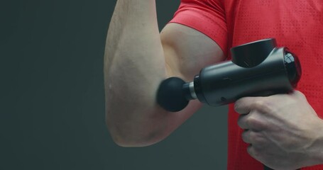 Percussion massager, sports guy massaging hand to relieve muscle pain, post-workout recovery routines, close up