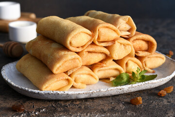 Thin pancakes with cottage cheese on a dark concrete background. Platbands. National, traditional dish of Belarus and Ukraine.