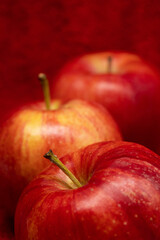 Red apples isolated in red background