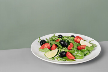 Fresh salad with vegetables on big white plate
