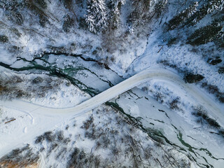 Curvy Road Brodge over Frozen River. Winter Landscape in Mountains. Bieszczady Poland. Drone Top...