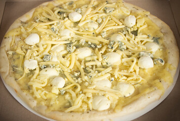 pizza 4 cheese, homemade, cheese pizza with mozzarella, dorblu, blue cheese. Fast food, semi-finished product, four cheese. High quality photo