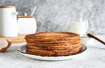 Stack of pancakes on the breakfast plate on a light background. Pancakes in the morning for breakfast.