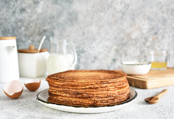 Stack of pancakes on the breakfast plate on a light background. Pancakes in the morning for breakfast.