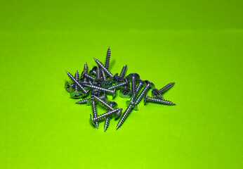 Screws still life large self tapping screws on green background