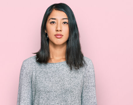 Beautiful asian young woman wearing casual clothes relaxed with serious expression on face. simple and natural looking at the camera.