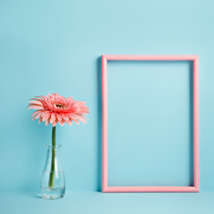 Pink border frame with gerbera in vase on blue background. Minimal floral concept. Mockup for special offers as advertising or other ideas. Empty place for inspirational, motivational text or quote.