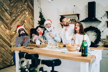 Merry friends gathering for Christmas party celebration