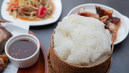 Warm steamed sticky rice, put in a casserole. bamboo container for holding cooked glutinous rice. A popular staple food in Northeastern Thailand.